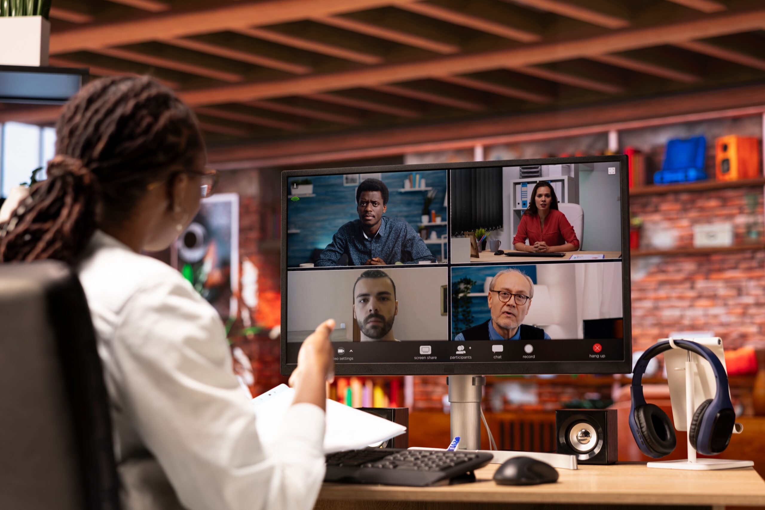 Remote employee on video call organising calendar with coworkers from home desk, supported by Fluid Resourcing services