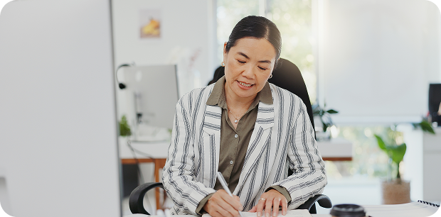A woman writing notes at desk, symbolising Fluid Resourcing and access to skilled virtual talent from the Philippines