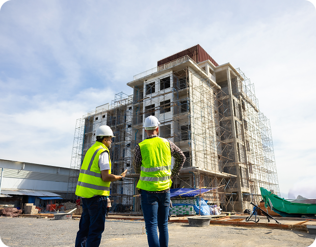 Two construction workers stand in front of a building, representing Fluid Resourcing with virtual talent from the Philippines