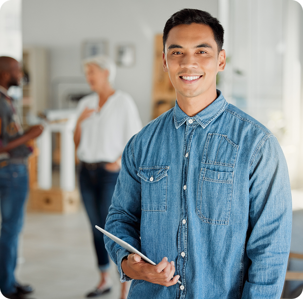 Man in denim shirt smiling at camera, reflecting Fluid Resourcing and a people-first approach to smarter team performance