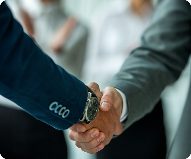 A handshake between two business people in front of an audience, symbolising partnership and Fluid Resourcing in the Philippines