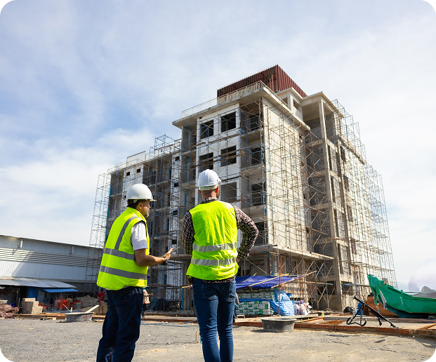 Two construction workers stand in front of a building, representing Fluid Resourcing with virtual talent from the Philippines