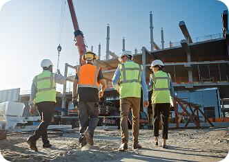 Four construction workers moving through an active site, reflecting Fluid Resourcing virtual talent collaboration in construction workforce solutions for In Person Relocations